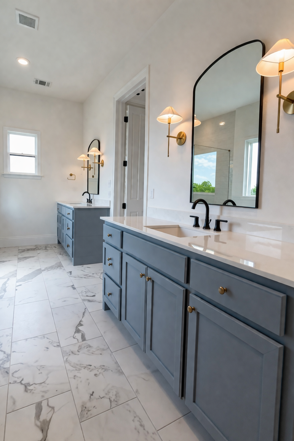 Primary bathroom with dual marble vanity and gold fixtures