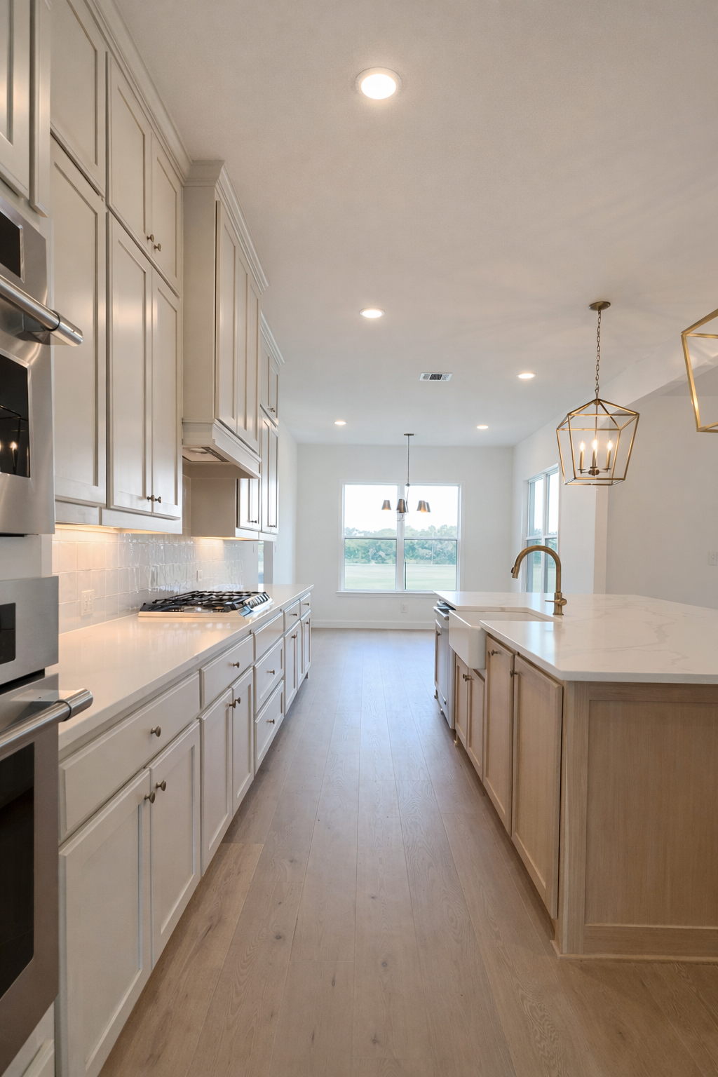 Modern kitchen with cream cabinetry and marble countertops